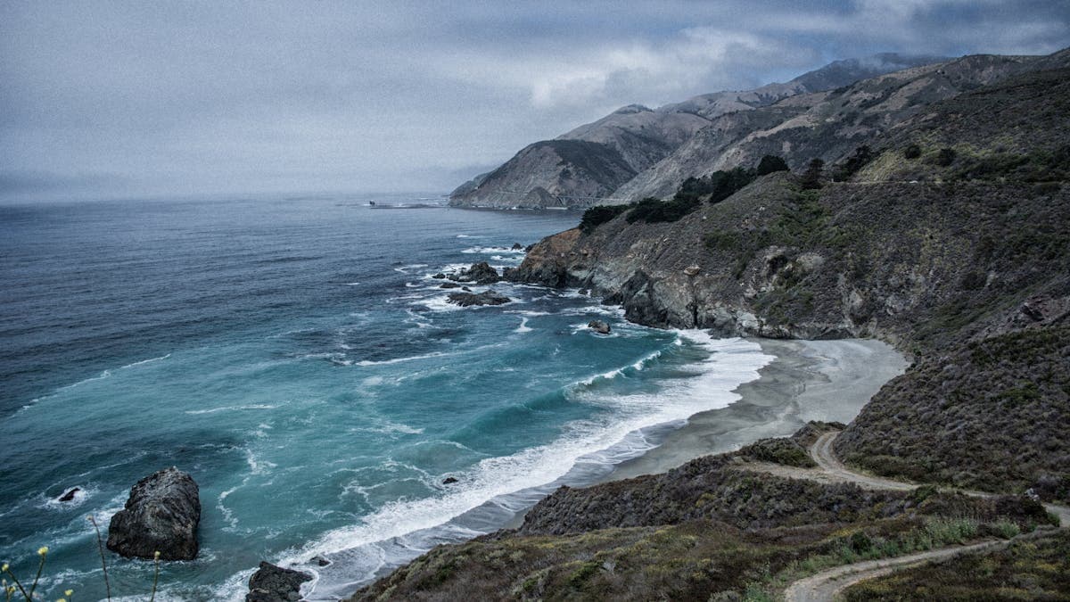 Pacific surf breaking along the Big Sur coastline below the Santa Lucia Mountains